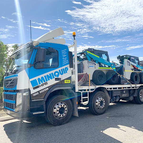 Lifting and transporting mini excavators with Miniquip Hire truck. Reliable equipment rental services in Australia.